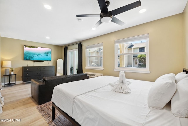 bedroom with ceiling fan and light hardwood / wood-style floors