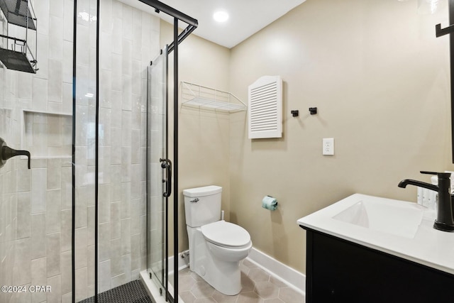 bathroom featuring toilet, vanity, tile patterned floors, and an enclosed shower