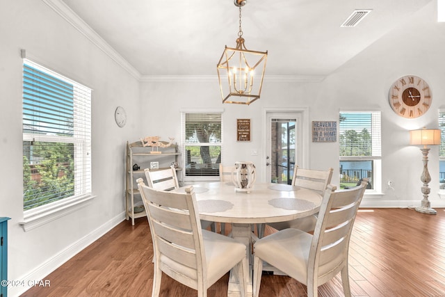 dining area featuring ornamental molding, dark hardwood / wood-style floors, and a notable chandelier