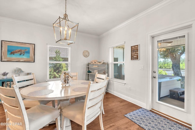 dining room featuring hardwood / wood-style flooring, ornamental molding, and a chandelier