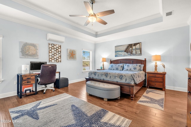 bedroom featuring a raised ceiling, a wall mounted AC, ceiling fan, and crown molding