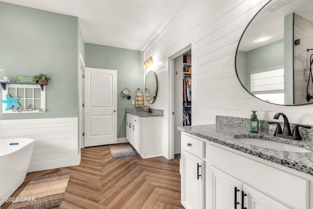 bathroom with plus walk in shower, vanity, and parquet floors