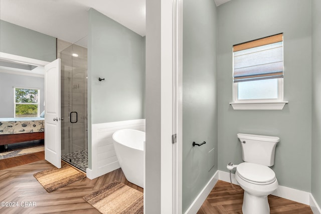 bathroom with toilet, separate shower and tub, and parquet floors