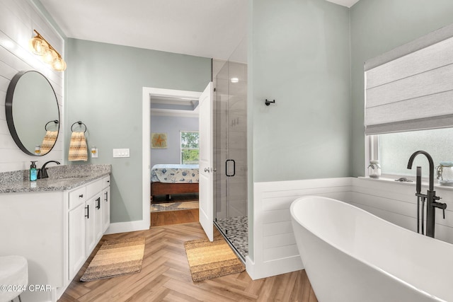 bathroom featuring parquet flooring, vanity, and independent shower and bath