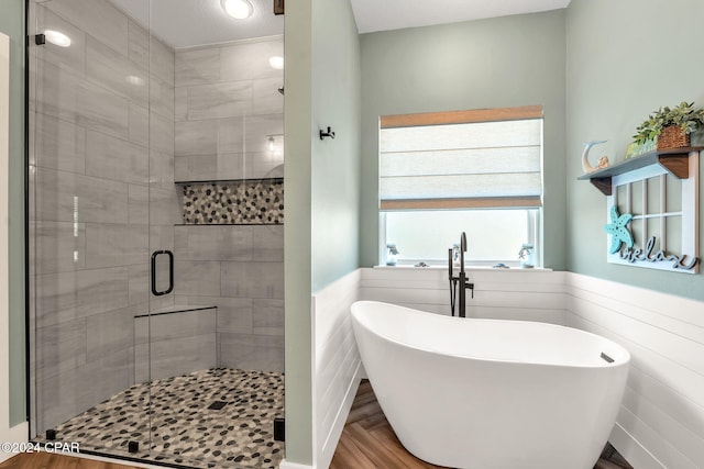 bathroom featuring separate shower and tub and tile walls