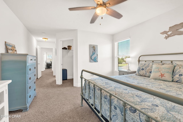 bedroom featuring ceiling fan and carpet