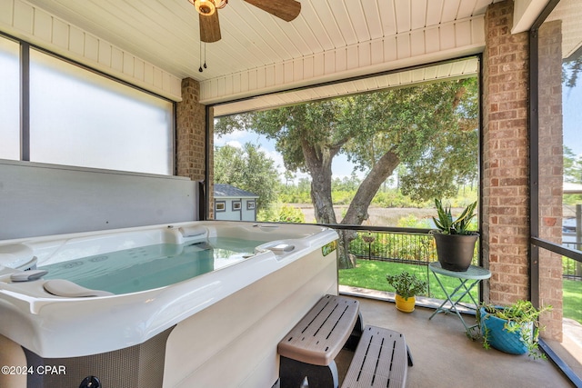 sunroom with a jacuzzi and ceiling fan