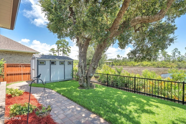 view of yard with an outbuilding and a water view