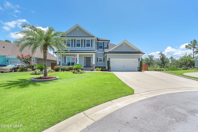 view of front of house featuring a front lawn, covered porch, and a garage