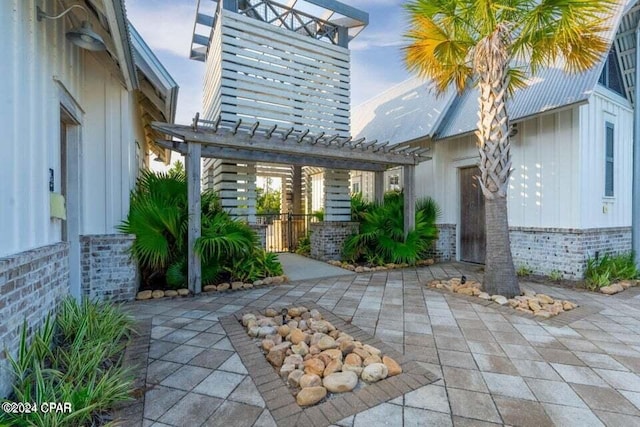 property entrance with a pergola and a patio