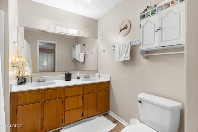7707 Shadow Bay Dr, Panama City, FL 32404 - bathroom featuring vanity, a textured ceiling, and toilet