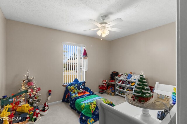 7707 Shadow Bay Dr, Panama City, FL 32404 - playroom with ceiling fan, carpet floors, and a textured ceiling