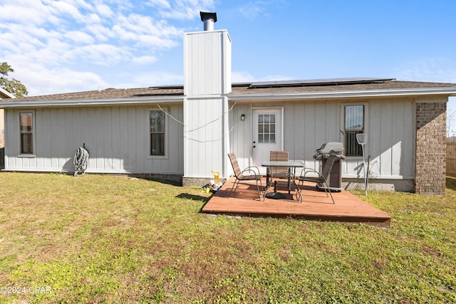 7707 Shadow Bay Dr, Panama City, FL 32404 - rear view of house featuring a yard, a deck, and solar panels