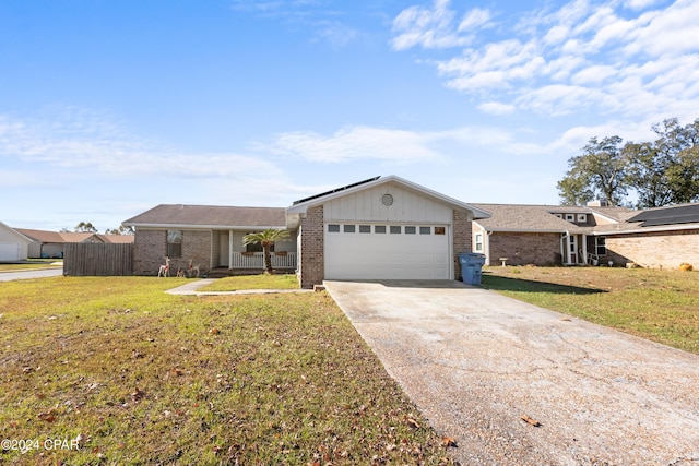 ranch-style home with a garage and a front lawn