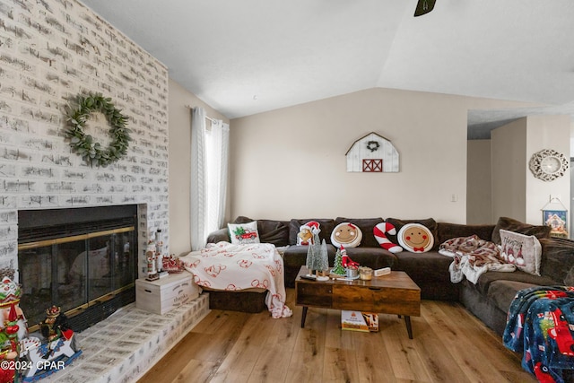 7707 Shadow Bay Dr, Panama City, FL 32404 - living room featuring lofted ceiling, a fireplace, and light wood-type flooring