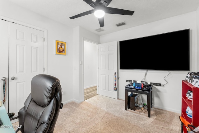 carpeted office with ceiling fan