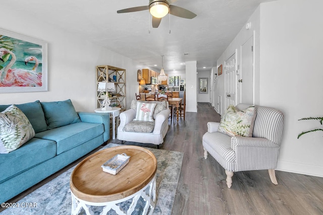 living room with ceiling fan and dark wood-type flooring