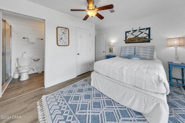 bedroom featuring wood-type flooring, a closet, ensuite bathroom, and ceiling fan