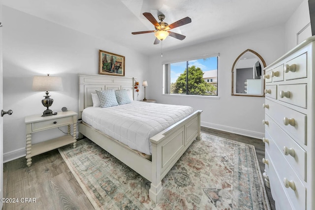 bedroom with ceiling fan and dark wood-type flooring