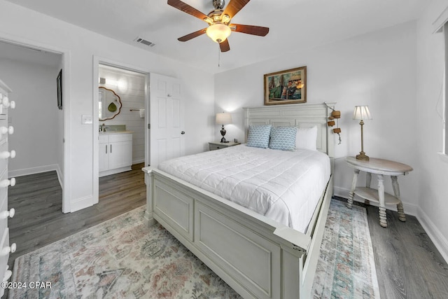 bedroom featuring connected bathroom, ceiling fan, and dark hardwood / wood-style floors