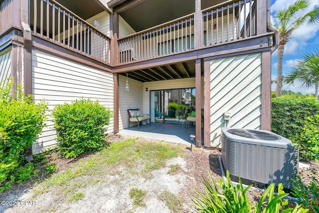 rear view of property featuring a patio area and cooling unit