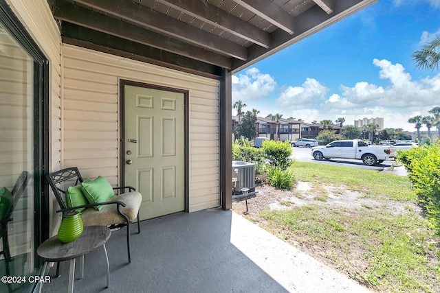 entrance to property featuring a patio and central AC unit