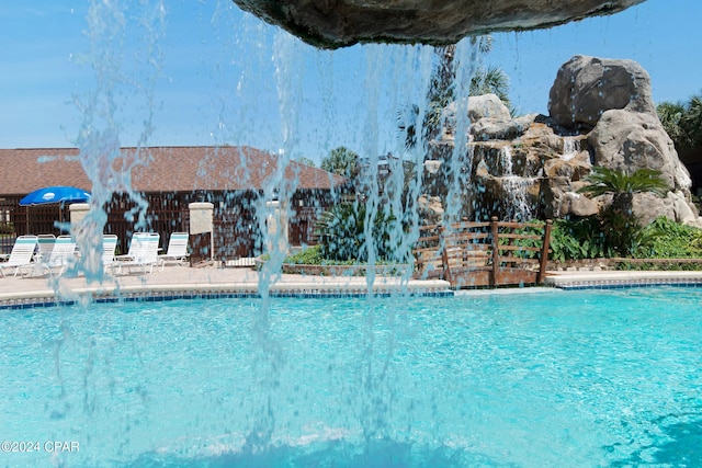 view of swimming pool featuring pool water feature