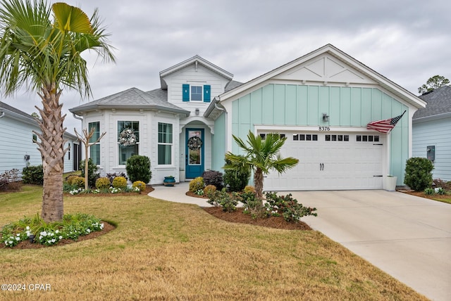 view of front of home with a front yard and a garage