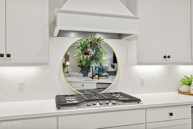 kitchen with white cabinetry, sink, and stainless steel gas stovetop