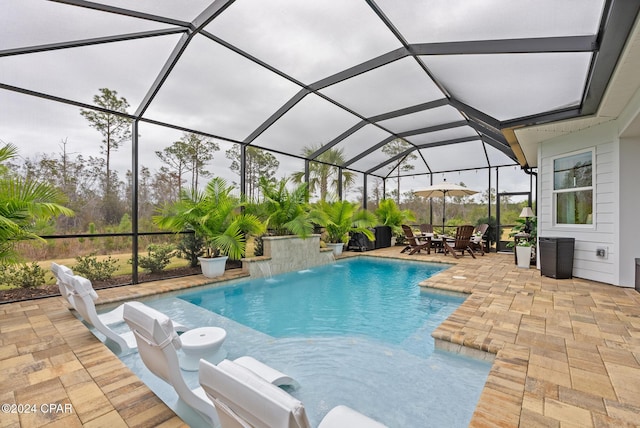 view of swimming pool with a patio, pool water feature, and glass enclosure