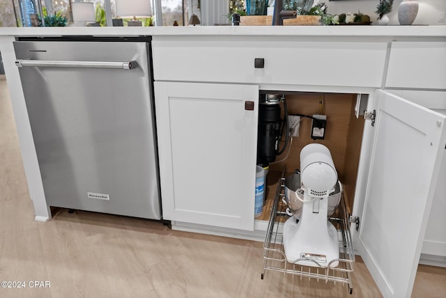 interior details with dishwasher, white cabinets, and light hardwood / wood-style floors