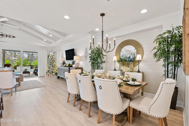 dining space featuring beam ceiling, crown molding, light wood-type flooring, and an inviting chandelier