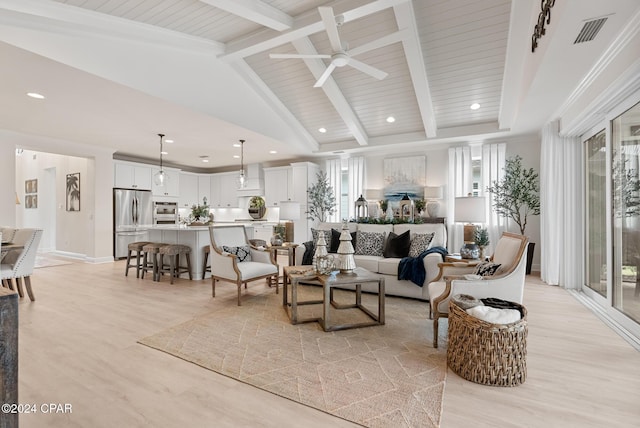 living room featuring vaulted ceiling with beams, ceiling fan, and light hardwood / wood-style floors