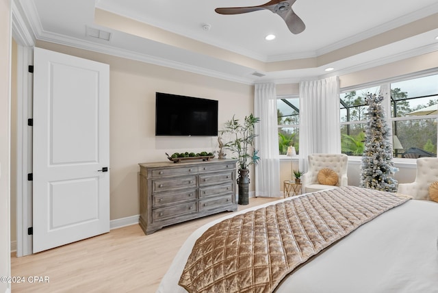 bedroom with a raised ceiling, ceiling fan, ornamental molding, and light wood-type flooring