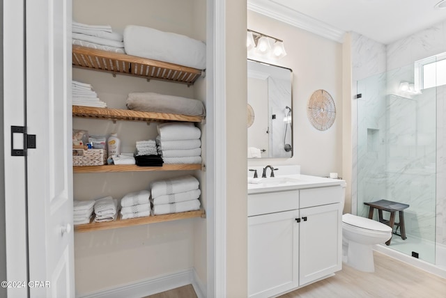 bathroom with vanity, a shower with door, hardwood / wood-style flooring, toilet, and ornamental molding