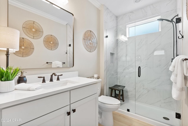 bathroom featuring crown molding, wood-type flooring, an enclosed shower, toilet, and vanity