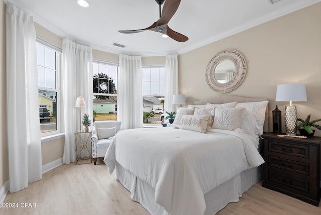 bedroom with ceiling fan, crown molding, and light hardwood / wood-style flooring