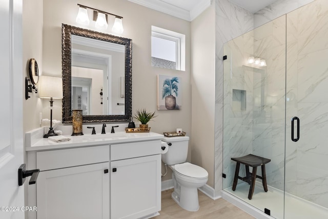 bathroom with hardwood / wood-style floors, vanity, crown molding, toilet, and an enclosed shower