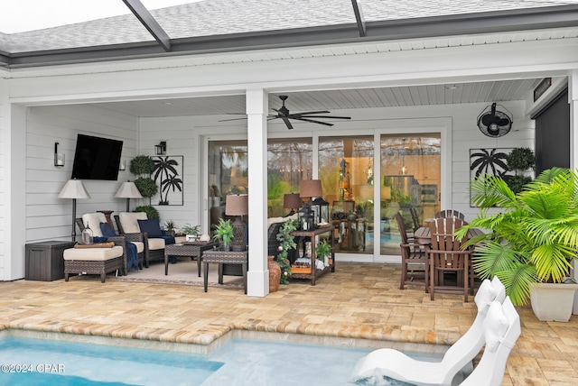 view of pool with ceiling fan, a patio, and glass enclosure