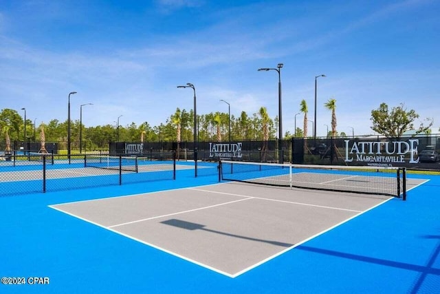 view of tennis court featuring basketball court