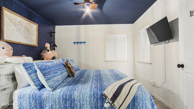 bedroom with hardwood / wood-style floors and ceiling fan