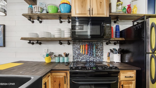 kitchen with decorative backsplash, butcher block counters, and black appliances