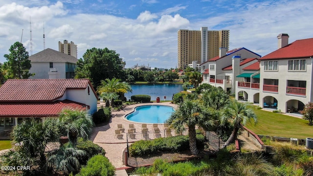 view of pool featuring a patio and a water view