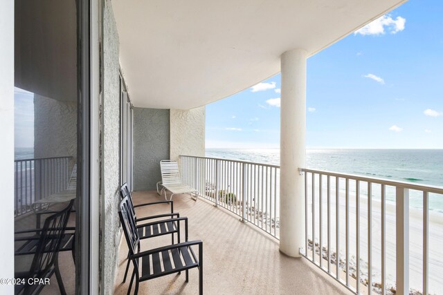 balcony with a beach view and a water view