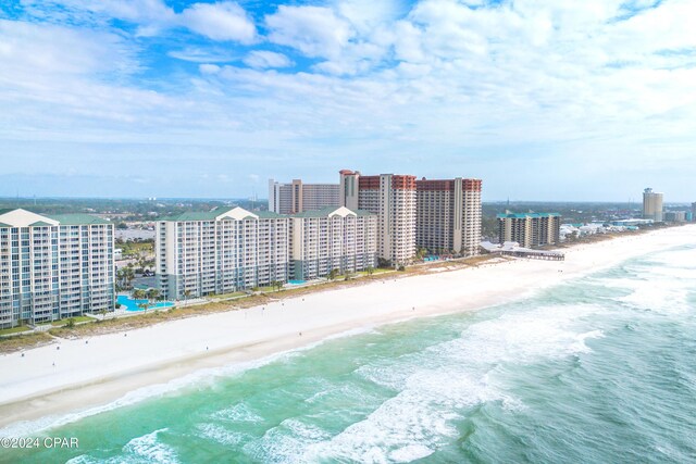 birds eye view of property featuring a beach view and a water view