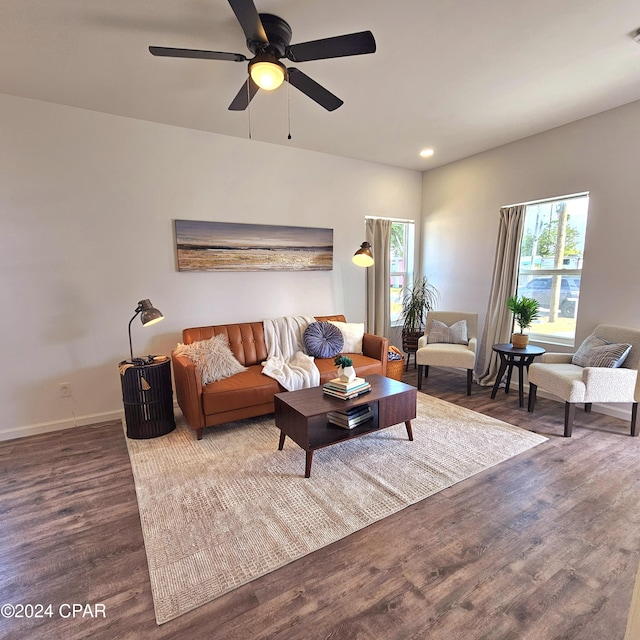 living room featuring hardwood / wood-style floors and ceiling fan