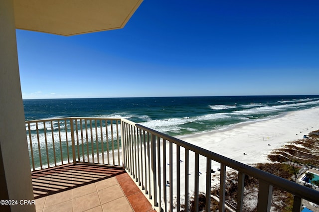 balcony featuring a water view and a view of the beach