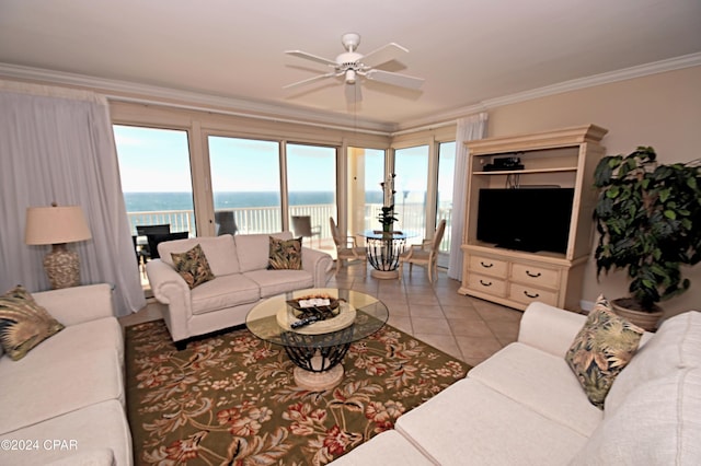 living area with light tile patterned floors, ceiling fan, a wealth of natural light, and crown molding