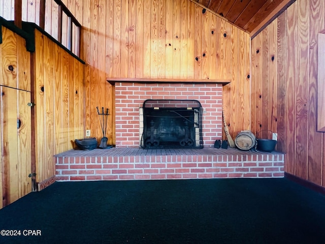 unfurnished living room with a fireplace, wooden ceiling, and wooden walls