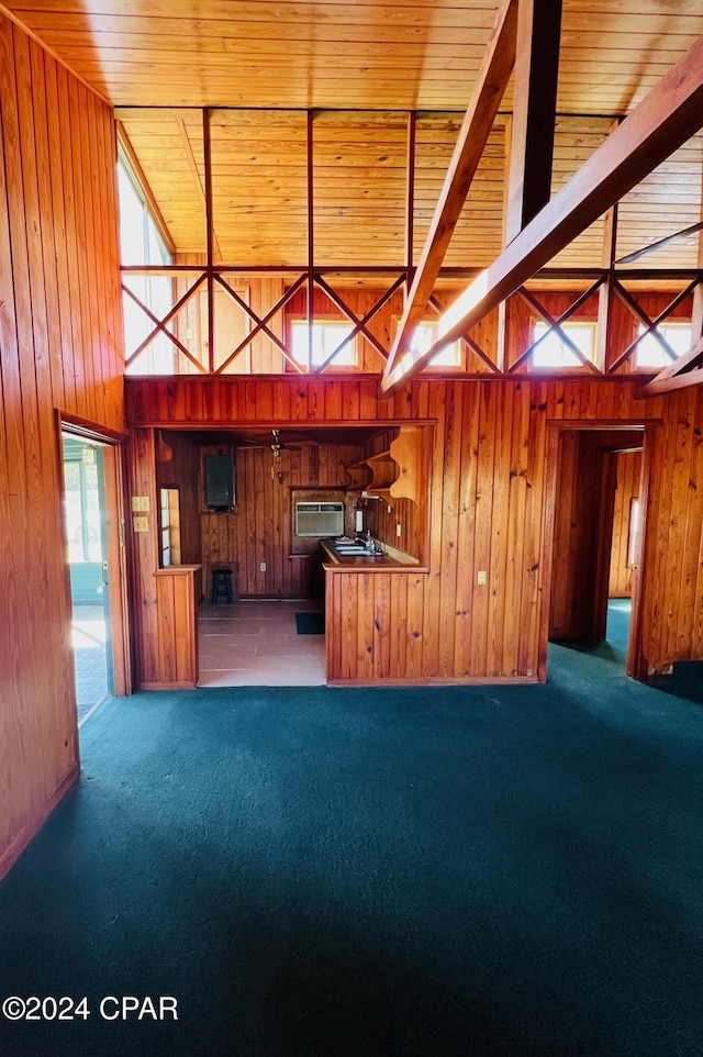 unfurnished living room with carpet, wooden ceiling, wooden walls, and a wall mounted AC